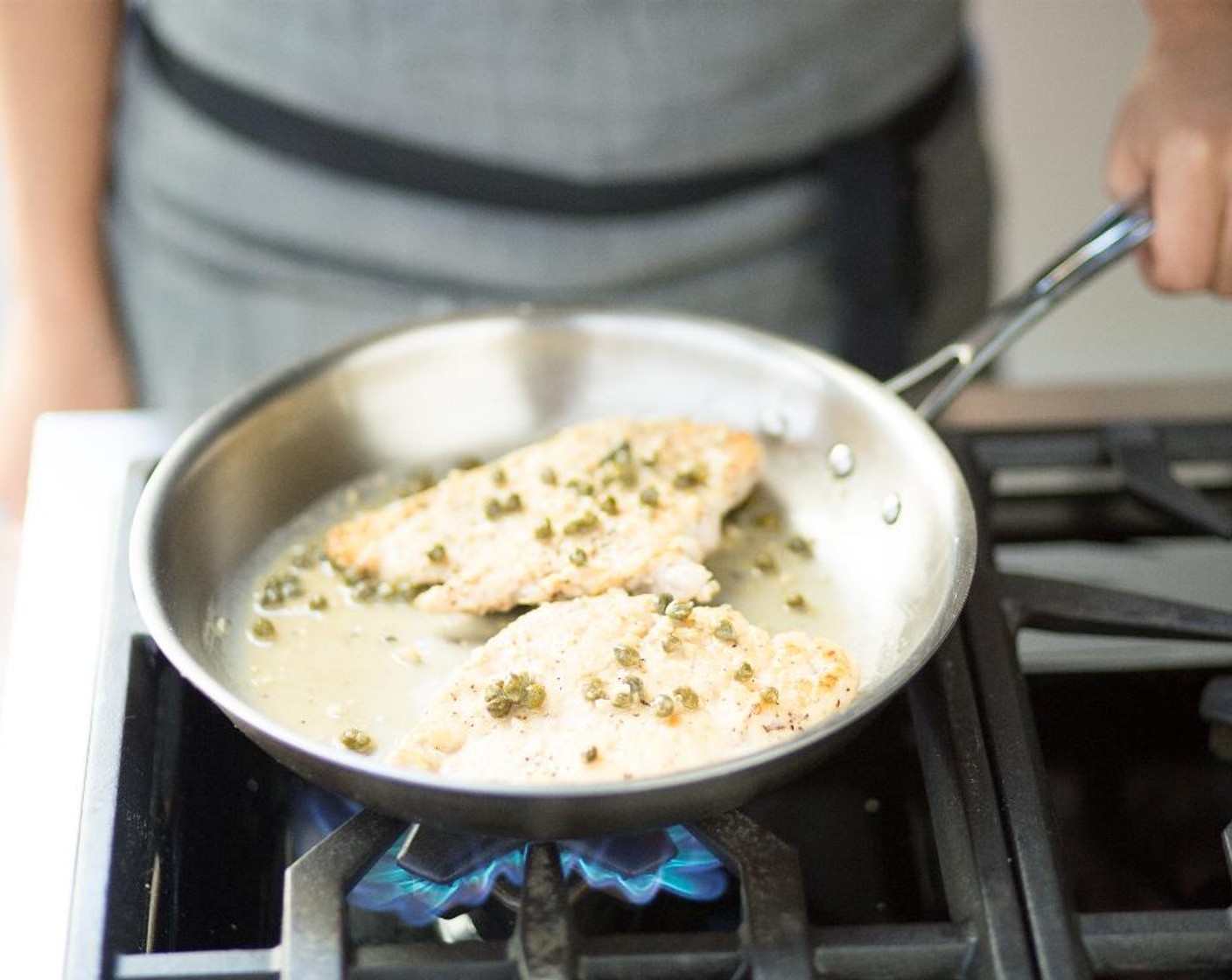 step 12 Add the roasted lemon juice, White Cooking Wine (4 Tbsp), lemon zest, Capers (2 Tbsp) and chicken broth. Reduce liquid until chicken is coated and sauce is slightly thickened.