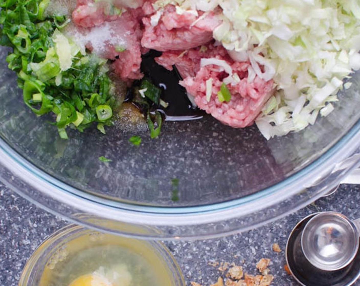 step 1 Peel and grate the knob of Fresh Ginger (1 in). In a large bowl, combine Dried Shrimp (2 tsp), Sherry Wine (2 tsp), Green Cabbage (1 1/2 cups), Kosher Salt (1/2 tsp), Ground Pork (1 lb), Fresh Chives (1 bunch), Garlic (1 clove) and ginger.