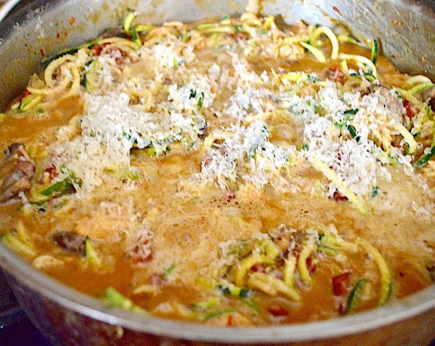 step 6 Return the chicken and veggies to the pan and also add in Zucchini (4). Stir everything well, then sprinkle the Parmesan Cheese (4 Tbsp) on top. Let it bubble for a minute on the stove, then transfer it to the oven to bake for 15 minutes.