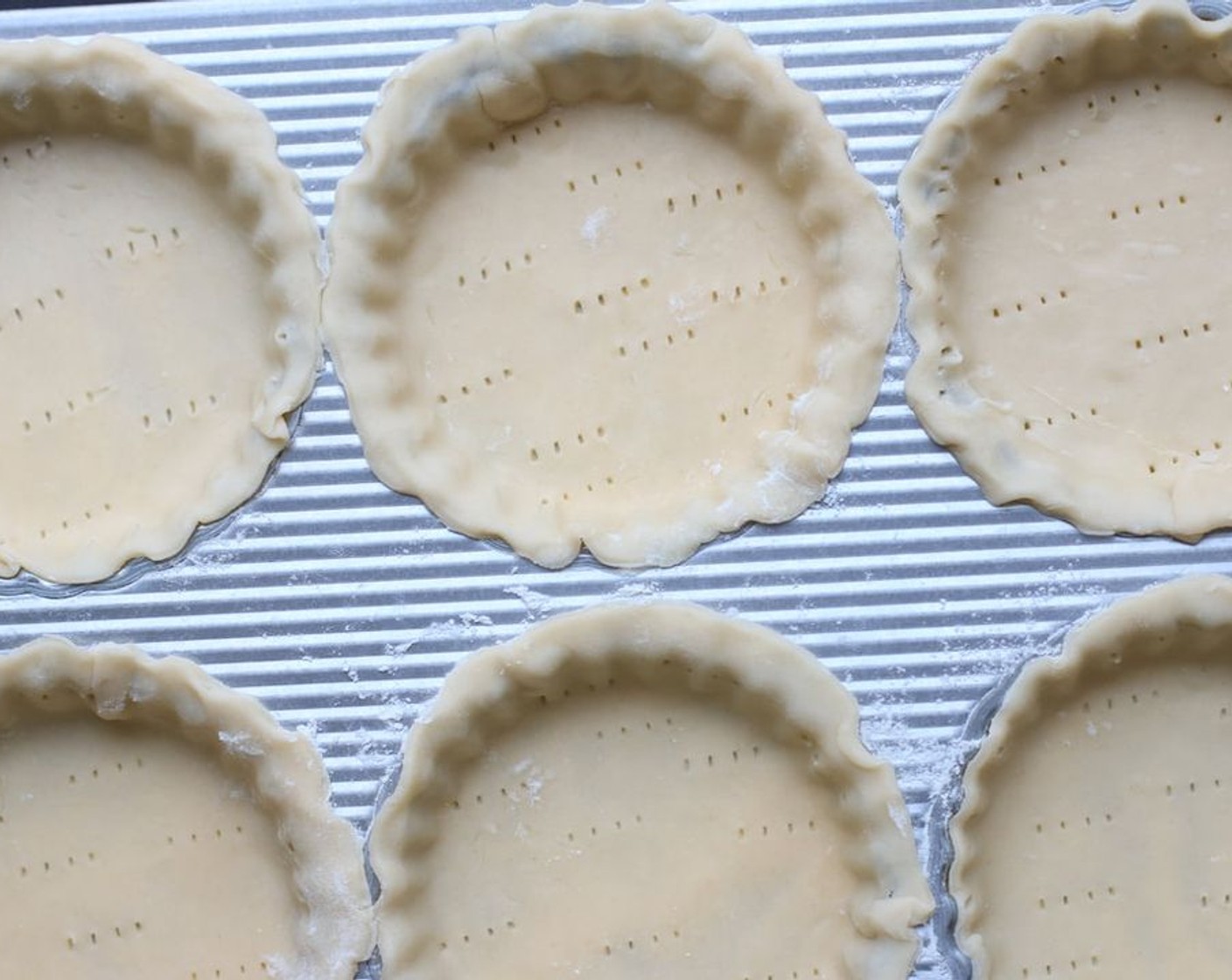 step 6 In a small bowl, beat Eggland's Best Classic Egg (1) and Milk (1 Tbsp) with a fork until frothy. Using a pastry brush, lightly brush the edge of each tart crust with the egg wash.  Poke bottom and sides of each tart shell with a fork.