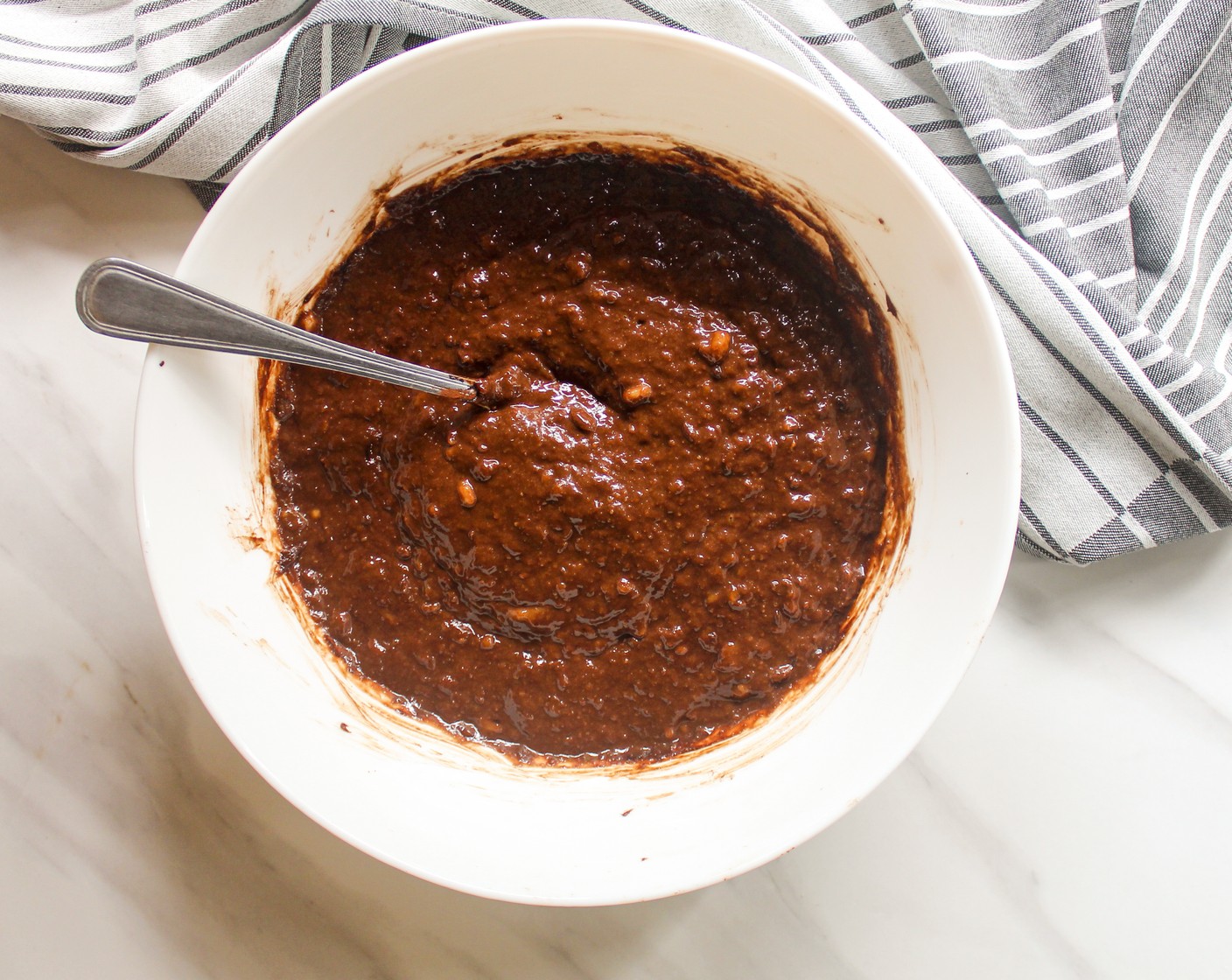 step 3 Add in the Peanut Butter (1/2 cup) and Unsweetened Cocoa Powder (4 Tbsp) into the mashed bananas. Combine till well mixed.