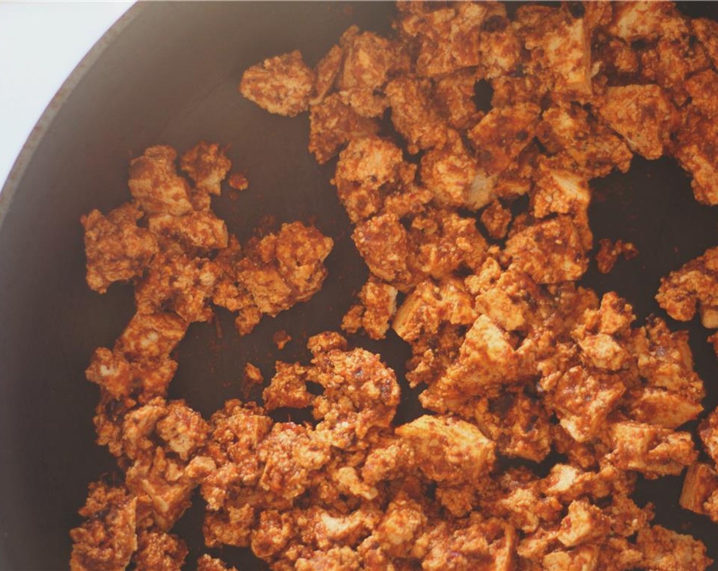 step 6 Sear the tofu in a hot pan until it develops a little crunchy texture. Add the remaining hot sauce throughout the cooking process to keep moist and maintain flavor.