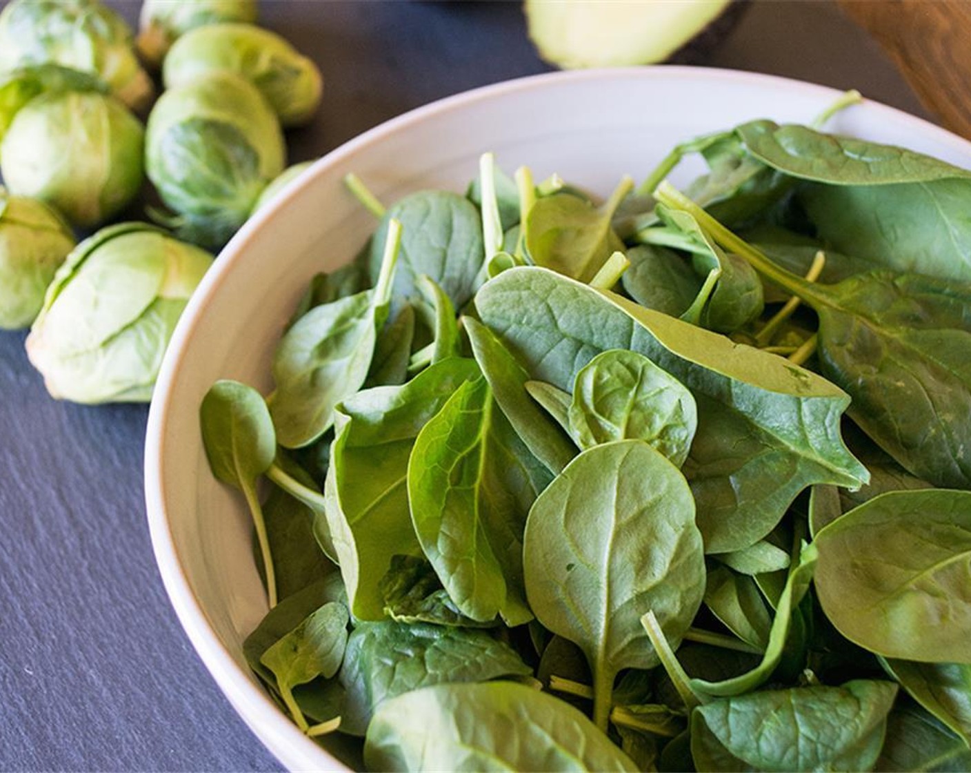 step 8 While veggies cook, fill two bowls with Fresh Spinach (4 cups), Eggland's Best Classic Eggs (2), GOYA® Chick Peas (4 Tbsp), Pecans (4 Tbsp), Feta Cheese (3 Tbsp), and Avocado (1).