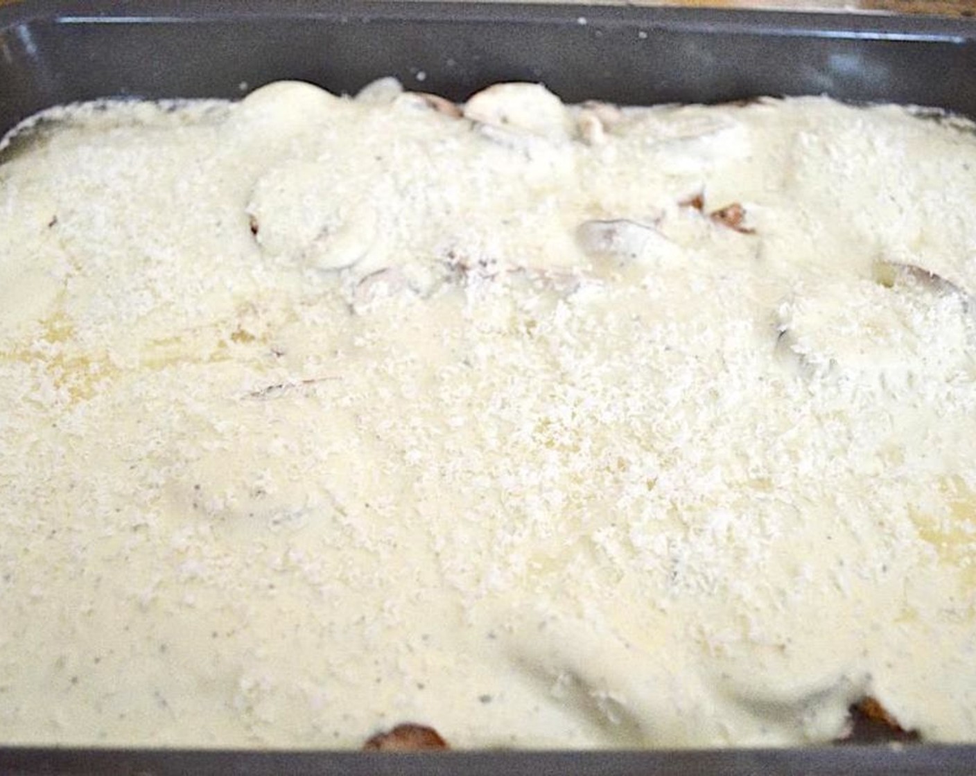 step 3 Evenly distribute the Cremini Mushrooms (2 1/4 cups) and Long Grain White Rice (1 cup) over and around the chicken, then pour in the Avocado Ranch Dressing (3 cups) and Chicken Stock (1 cup). Finally, sprinkle the Parmesan Cheese (4 Tbsp) evenly on top.