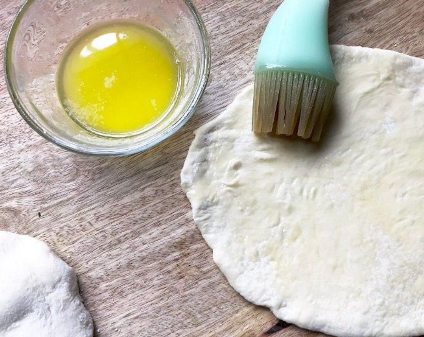 step 8 When ready to cook, preheat a large cast-iron or heavy-duty skillet over medium-high heat until it is extremely hot. Be sure to have a matching lid nearby. Melt half the Salted Butter (4 Tbsp). Lightly brush both sides of each dough oval with the melted butter as you proceed.