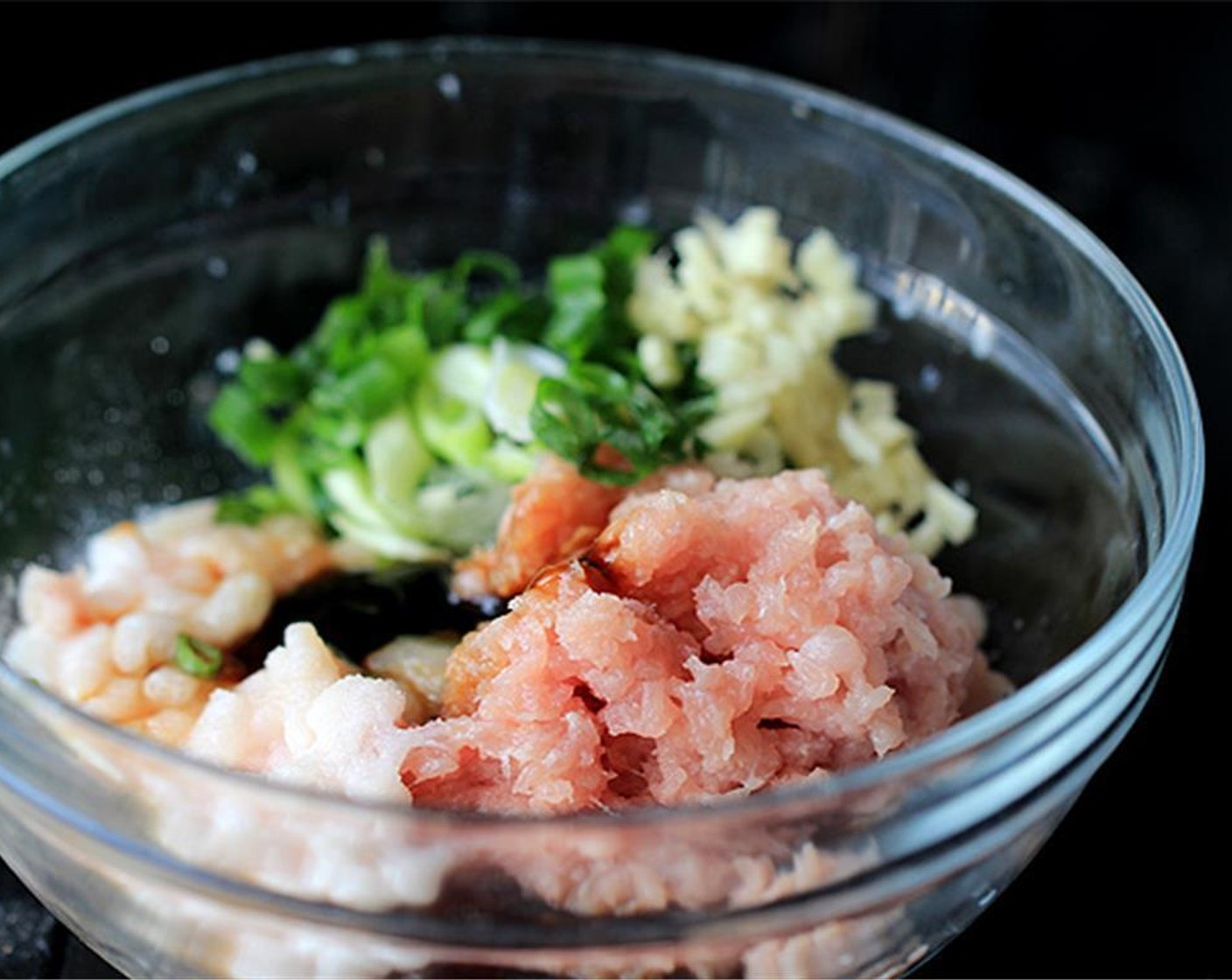step 1 To make the filling, combine the Ground Pork (1 cup), Scallions (2 Tbsp), Fresh Ginger (1 tsp), Eggland's Best Classic Egg (1), Shrimp (1/2 cup), Ground Black Pepper (1/2 tsp), Sesame Oil (1/2 tsp), Oyster Sauce (1 Tbsp) and Salt (to taste).
