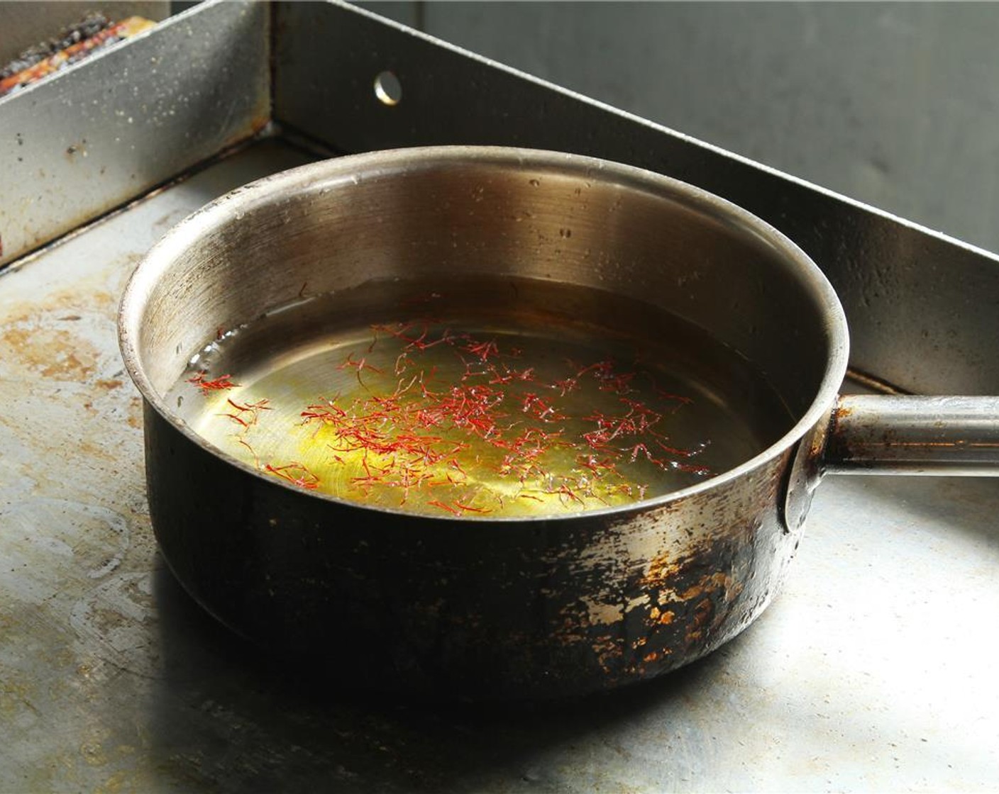 step 8 In a pot, add cold Water (3 1/3 Tbsp) and Saffron Threads (1 pinch). Bring it to simmer, then remove from heat. Heat Lobster Stock (3 3/4 cups) and set aside.