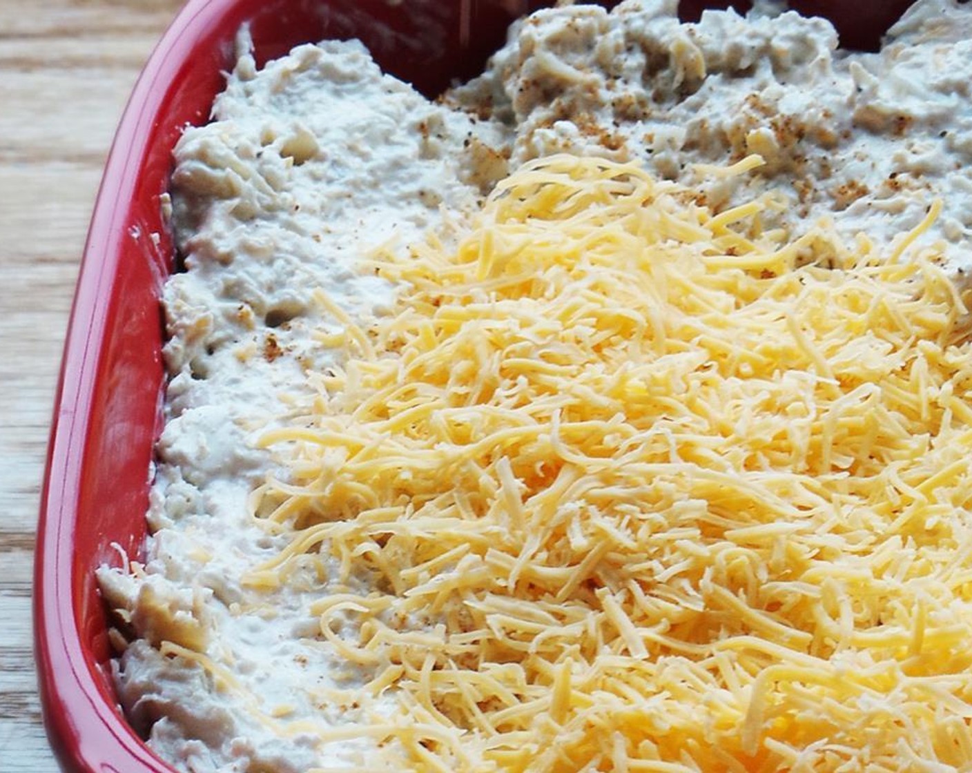step 3 Slowly add the Old Bay® Seasoning (1 tsp) until desired taste is achieved. Pick through the Lump Crab Meat (1 lb) for shells and gently fold into the mix. Add to a baking dish and sprinkle remaining Shredded Cheddar Cheese (1/2 cup) over top.