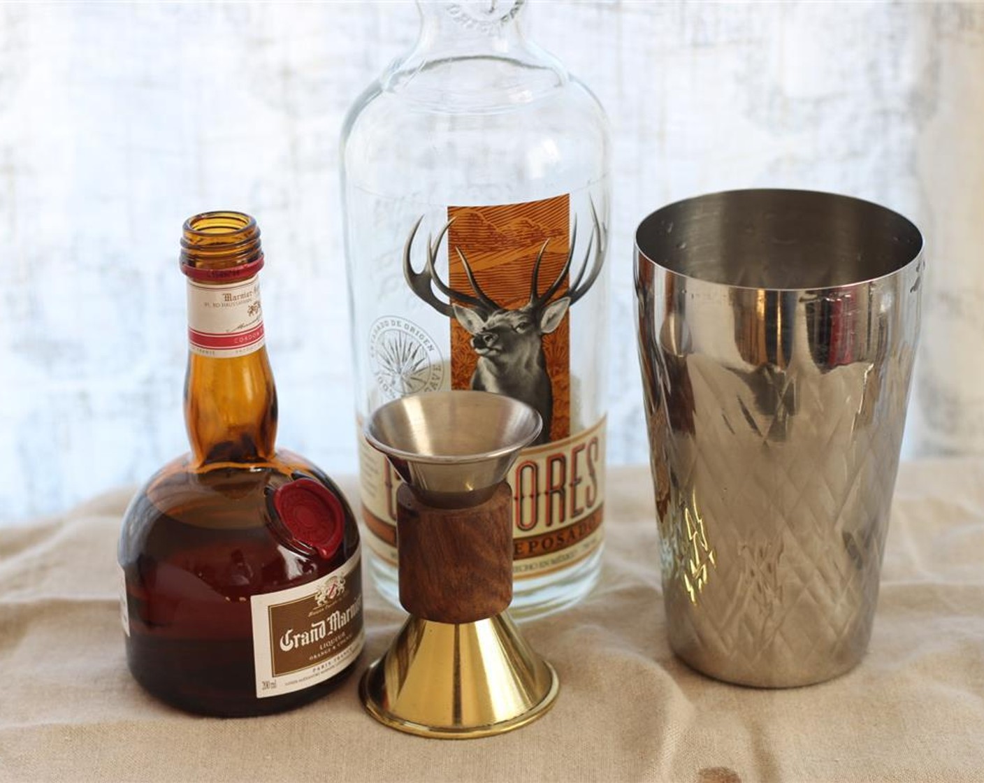step 11 In a cocktail shaker, combine Silver Tequila (4 fl oz), Grand Marnier (1 fl oz), 2 ounces of lime juice and 1.5 ounces of the ginger simple syrup. Add some ice and shake for 10 seconds.