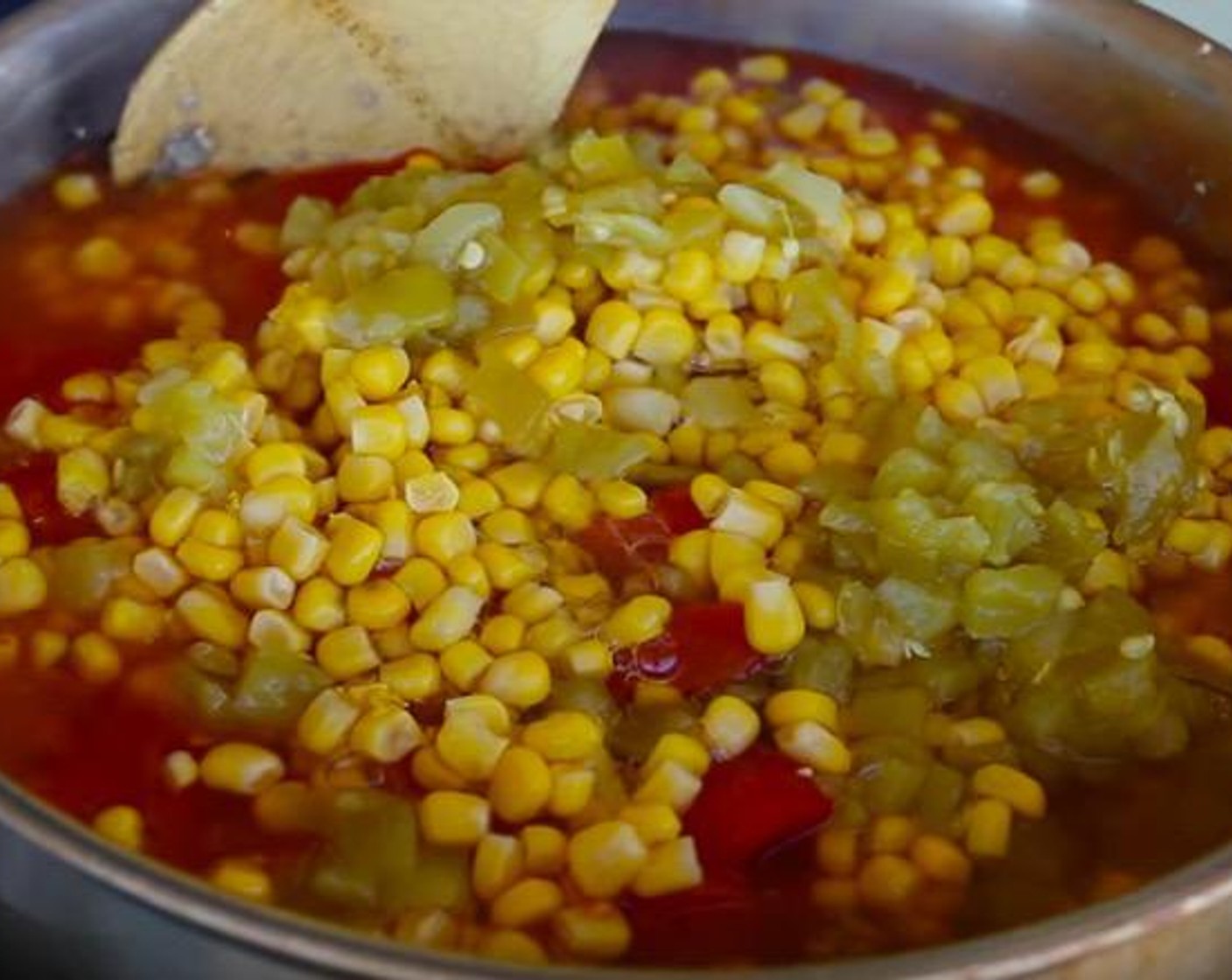 step 2 Add Taco Seasoning (1 pckg), Tomato Sauce (1 can), Diced Tomatoes (1 can), Sweet Corn (1 can), Mild Diced Green Chiles (1 can), and Beef Broth (2 cups). Mix everything together and bring to a boil.